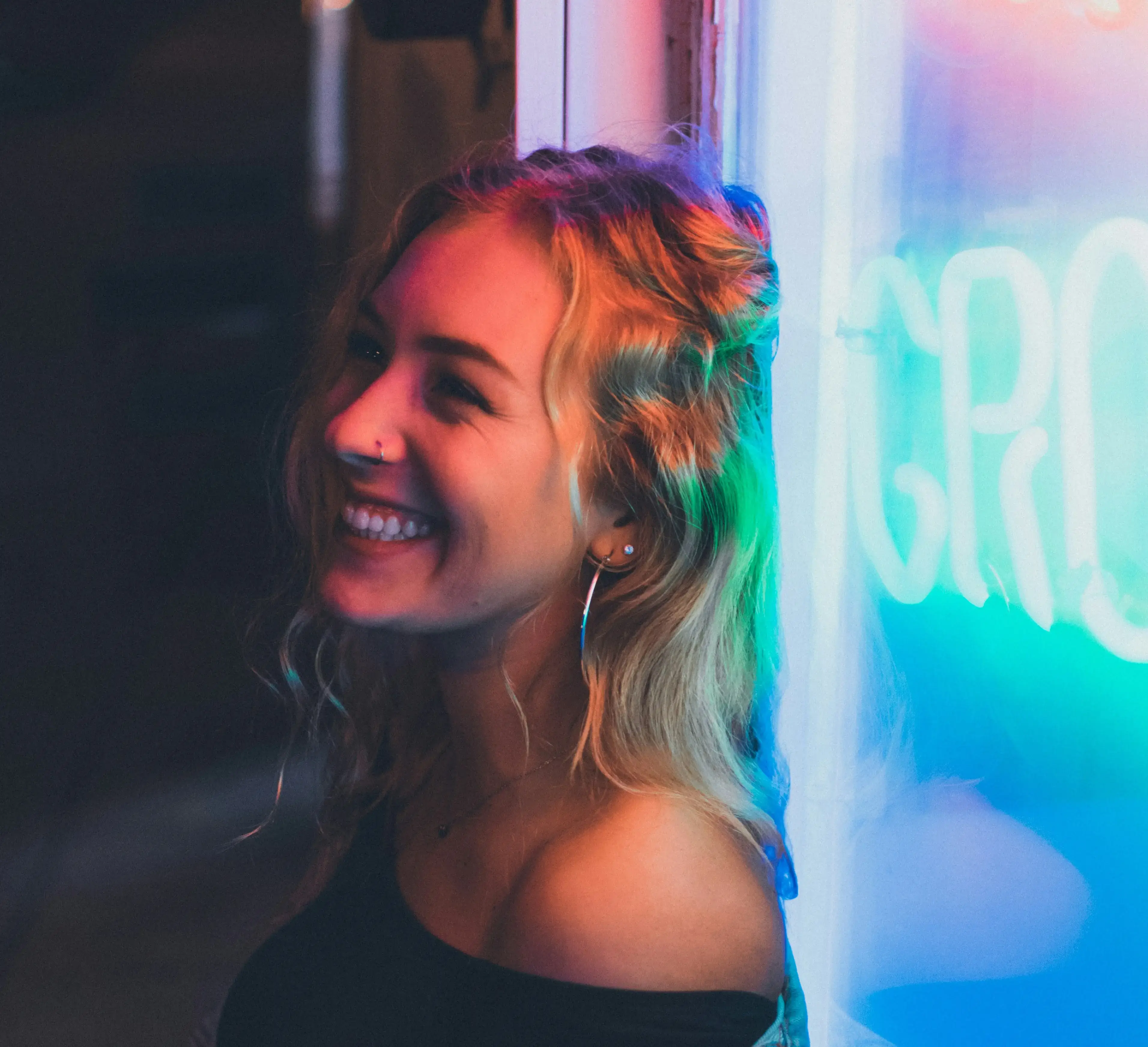 Creative professional in front of a neon sign